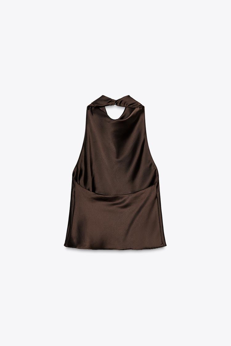 Halter neck top with open back. Back hidden button closure.