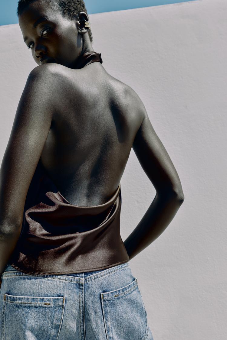 Halter neck top with open back. Back hidden button closure.