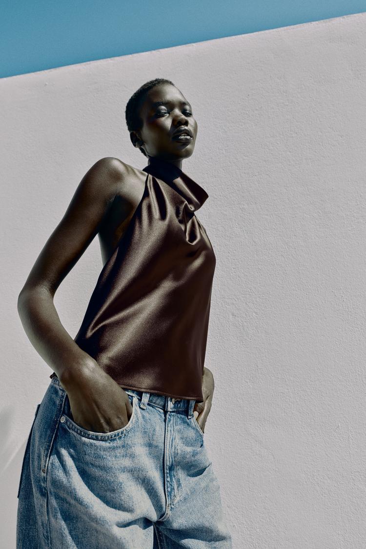 Halter neck top with open back. Back hidden button closure.