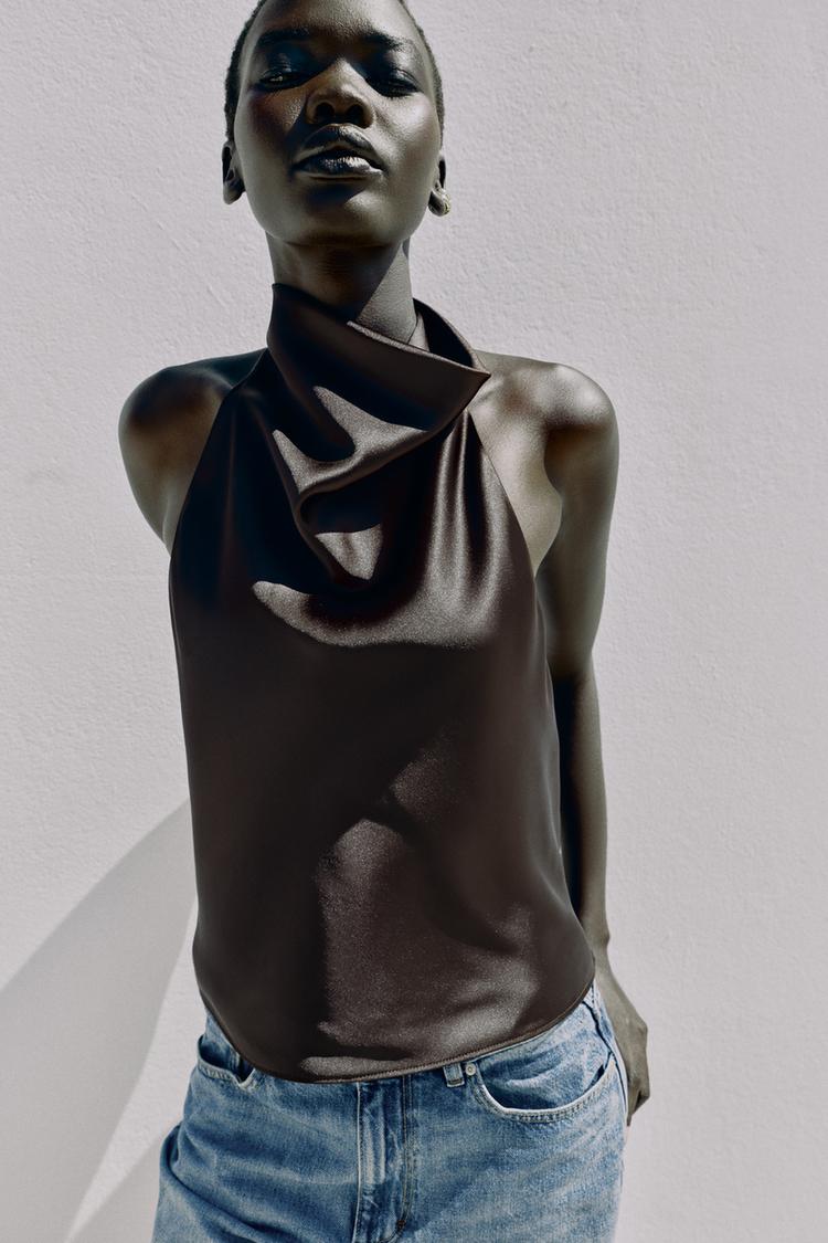 Halter neck top with open back. Back hidden button closure.